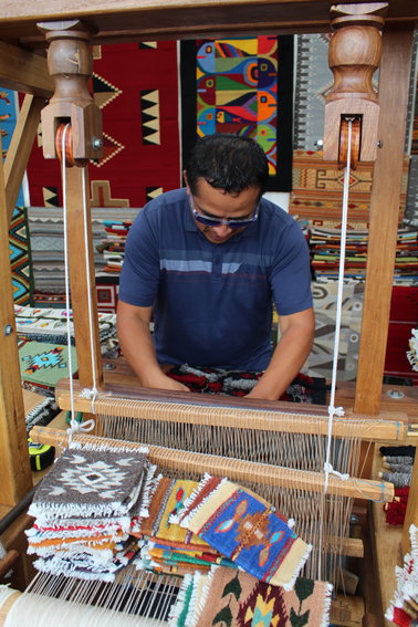 Zapotec weaver Mel Mendez works at the loom during the Golden Fine Arts Festival Aug. 20 in downtown Golden. Mendez, who's from Prescott, Arizona, was the featured artist at this year's festival. The posters and T-shirts for the 32nd annual event feature his rug titled "Contemporary Fish."
